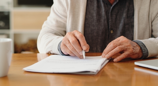 older man looking over documents