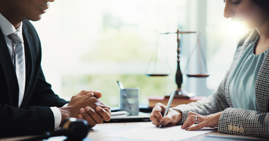 client signing documents with an attorney