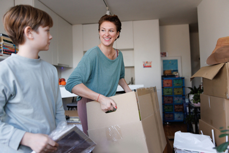 mother and son packing up moving boxes