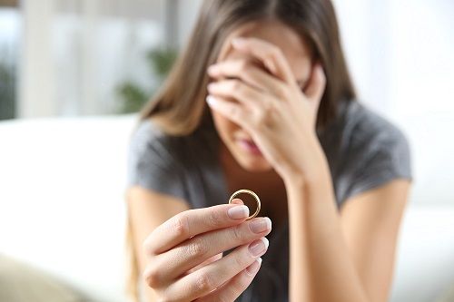 Woman holding ring for divorce